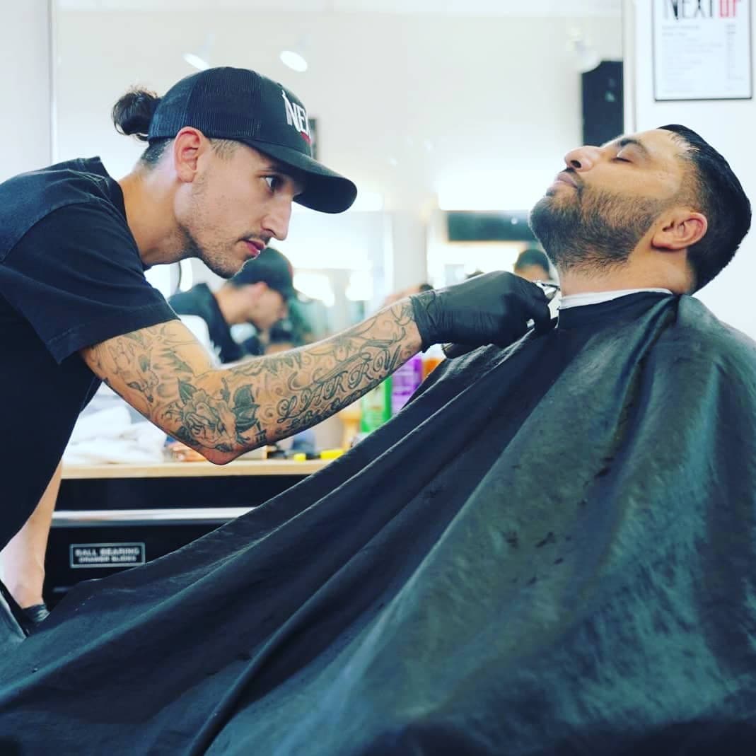 DK lining up a client's beard